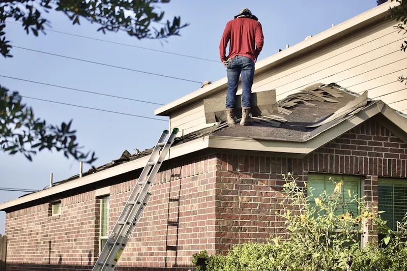 Professional roofer working on a residential roof in Nameless